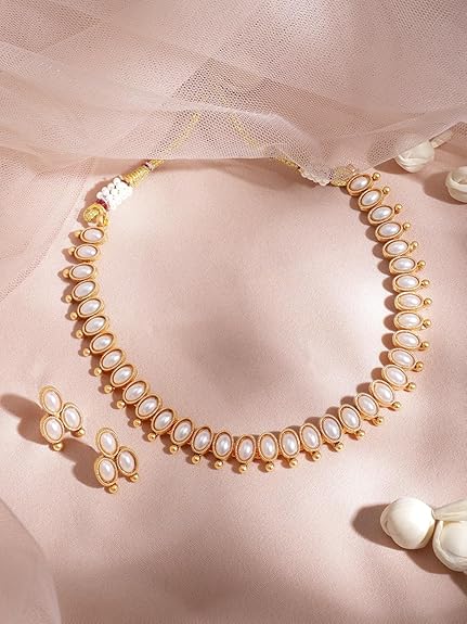 About this item Timeless Elegance: This 22KT gold-plated necklace set features sparkling stones, adding a touch of classic sophistication to any outfit. The warm gold complements various styles, making it a versatile choice for dressing up or down. Modern Take on a Classic Design: The combination of 22KT gold plating and sparkling stones creates a piece that's both timeless and current. It's perfect for someone who appreciates jewelry that blends tradition with a touch of modern flair. Unforgettable Sparkle: The sparkling stones in this set are sure to catch the light and add a touch of glamour. This set is perfect for those who love to add a bit of shine to their look.